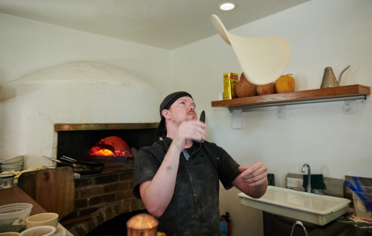 Chef tossing pizza dough in the air