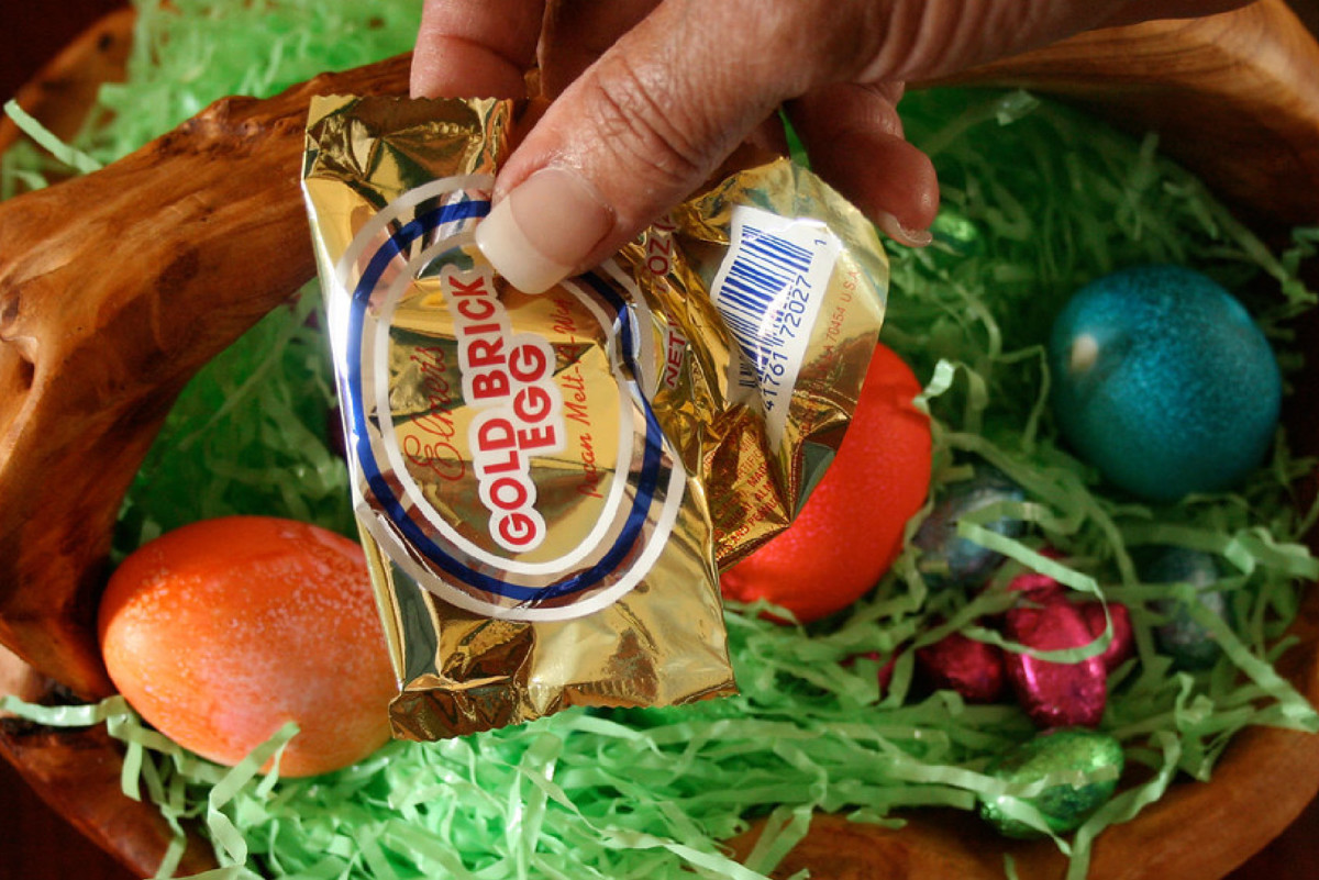 Woman holding a Gold Brick Egg over an Easter basket