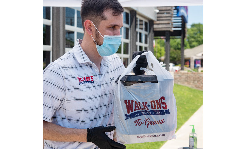 Walk-On's employee with to-geaux bag